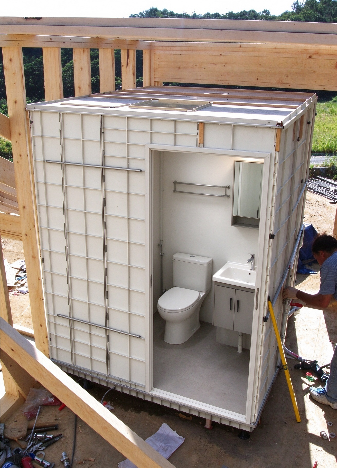 Modular bathroom pod installed inside a log cabin